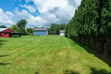 Discover the timeless charm of 9980 Tittabawassee, a historic on Golf Club At Apple Mountain in Michigan - for sale on GolfHomes.com, golf home, golf lot