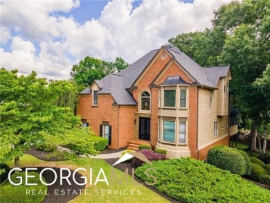 Welcome to your dream home! This exquisite four-bedroom property on Towne Lake Hills Golf Club in Georgia - for sale on GolfHomes.com, golf home, golf lot