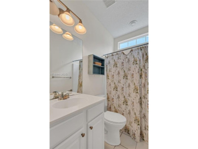 Enjoy Fabulous lagoon views from your large covered screen on Hidden Cypress Golf Club in South Carolina - for sale on GolfHomes.com, golf home, golf lot