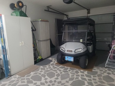 This great site-built home includes the golf cart in the garage on Chula Vista Executive Golf Course in Florida - for sale on GolfHomes.com, golf home, golf lot