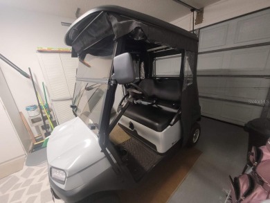 This great site-built home includes the golf cart in the garage on Chula Vista Executive Golf Course in Florida - for sale on GolfHomes.com, golf home, golf lot