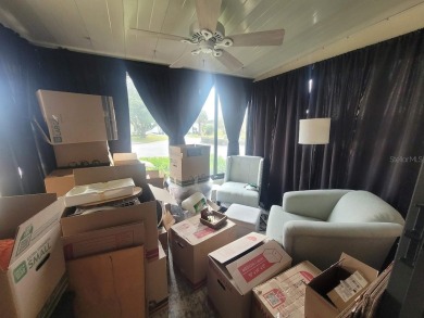 This manufactured home has a carport and a golf cart garage with on Orange Blossom Hills Golf and Country Club in Florida - for sale on GolfHomes.com, golf home, golf lot