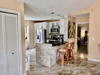 Discover the charm of this beautifully maintained 2-bedroom on Boca Pointe Country Club in Florida - for sale on GolfHomes.com, golf home, golf lot