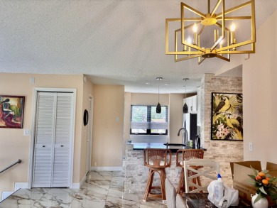 Discover the charm of this beautifully maintained 2-bedroom on Boca Pointe Country Club in Florida - for sale on GolfHomes.com, golf home, golf lot