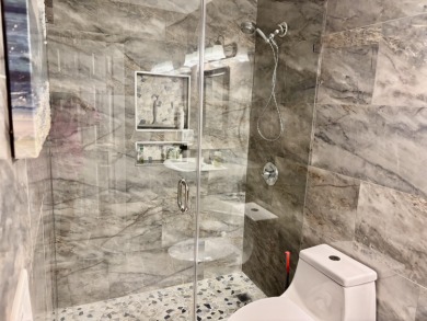 Discover the charm of this beautifully maintained 2-bedroom on Boca Pointe Country Club in Florida - for sale on GolfHomes.com, golf home, golf lot