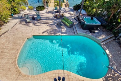 Secluded within the exclusive Boca Ciega Isle neighborhood, this on Isla Del Sol Yacht and Country Club in Florida - for sale on GolfHomes.com, golf home, golf lot