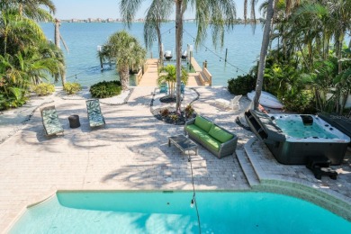 Secluded within the exclusive Boca Ciega Isle neighborhood, this on Isla Del Sol Yacht and Country Club in Florida - for sale on GolfHomes.com, golf home, golf lot