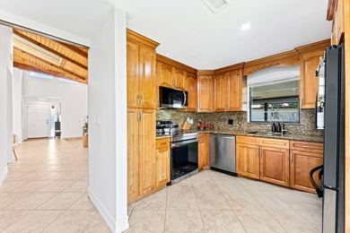 Welcome to this beautifully maintained 3-bedroom, 2-bathroom on Woodmont Country Club in Florida - for sale on GolfHomes.com, golf home, golf lot