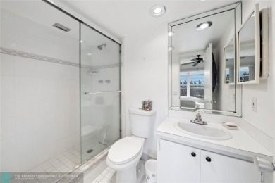 Enjoy golf views from a private screened patio in this updated on Palm-Aire Country Club and Resort - The Oaks in Florida - for sale on GolfHomes.com, golf home, golf lot