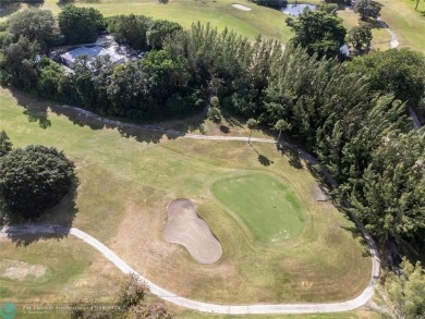 Enjoy golf views from a private screened patio in this updated on Palm-Aire Country Club and Resort - The Oaks in Florida - for sale on GolfHomes.com, golf home, golf lot