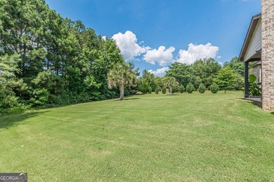 Discover this beautifully designed 4-sided brick home tucked on Crystal Lake Golf and Country Club in Georgia - for sale on GolfHomes.com, golf home, golf lot