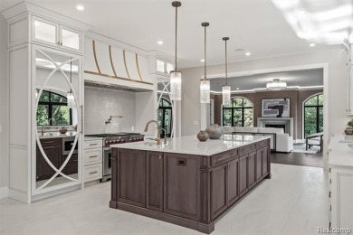 Set on over two acres along the coveted shores of all-sports on Orchard Lake Country Club in Michigan - for sale on GolfHomes.com, golf home, golf lot