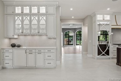 Set on over two acres along the coveted shores of all-sports on Orchard Lake Country Club in Michigan - for sale on GolfHomes.com, golf home, golf lot