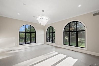 Set on over two acres along the coveted shores of all-sports on Orchard Lake Country Club in Michigan - for sale on GolfHomes.com, golf home, golf lot