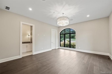 Set on over two acres along the coveted shores of all-sports on Orchard Lake Country Club in Michigan - for sale on GolfHomes.com, golf home, golf lot