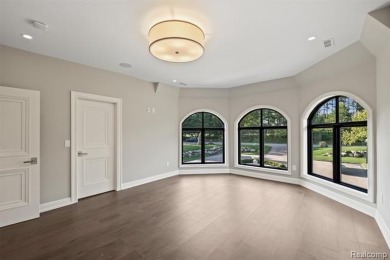Set on over two acres along the coveted shores of all-sports on Orchard Lake Country Club in Michigan - for sale on GolfHomes.com, golf home, golf lot