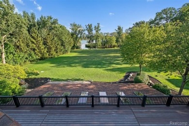 Set on over two acres along the coveted shores of all-sports on Orchard Lake Country Club in Michigan - for sale on GolfHomes.com, golf home, golf lot