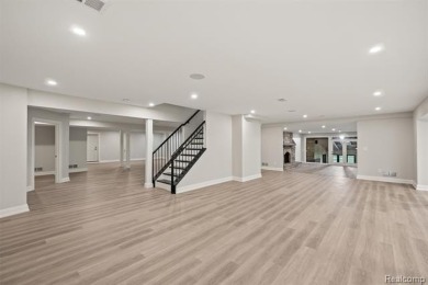 Set on over two acres along the coveted shores of all-sports on Orchard Lake Country Club in Michigan - for sale on GolfHomes.com, golf home, golf lot