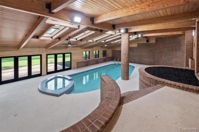 Set on over two acres along the coveted shores of all-sports on Orchard Lake Country Club in Michigan - for sale on GolfHomes.com, golf home, golf lot