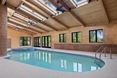 Set on over two acres along the coveted shores of all-sports on Orchard Lake Country Club in Michigan - for sale on GolfHomes.com, golf home, golf lot