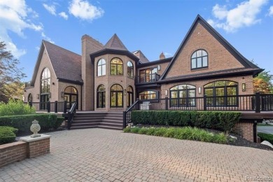 Set on over two acres along the coveted shores of all-sports on Orchard Lake Country Club in Michigan - for sale on GolfHomes.com, golf home, golf lot