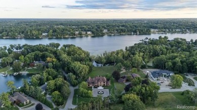 Set on over two acres along the coveted shores of all-sports on Orchard Lake Country Club in Michigan - for sale on GolfHomes.com, golf home, golf lot