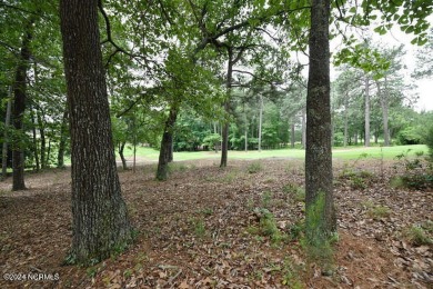 Be impressed by this beautiful wooded lot with almost 200 feet on Pinewild Country Club of Pinehurst in North Carolina - for sale on GolfHomes.com, golf home, golf lot