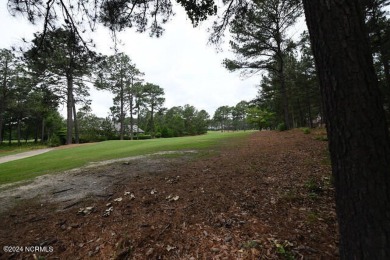 Be impressed by this beautiful wooded lot with almost 200 feet on Pinewild Country Club of Pinehurst in North Carolina - for sale on GolfHomes.com, golf home, golf lot