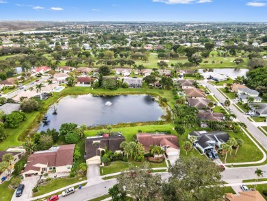 This stunning lakefront home in the highly desirable Elysium on Village Golf Club in Florida - for sale on GolfHomes.com, golf home, golf lot