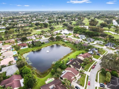 This stunning lakefront home in the highly desirable Elysium on Village Golf Club in Florida - for sale on GolfHomes.com, golf home, golf lot