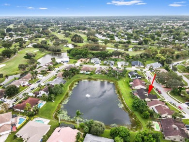 This stunning lakefront home in the highly desirable Elysium on Village Golf Club in Florida - for sale on GolfHomes.com, golf home, golf lot