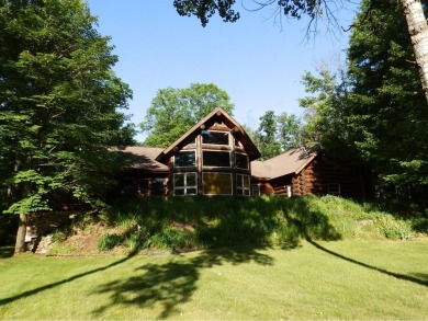 This stunning log home located on the 6th tee of Garland's on Garland Resort and Golf Club  in Michigan - for sale on GolfHomes.com, golf home, golf lot