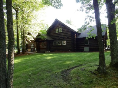 This stunning log home located on the 6th tee of Garland's on Garland Resort and Golf Club  in Michigan - for sale on GolfHomes.com, golf home, golf lot