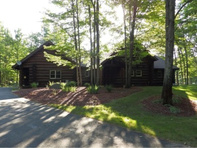 This stunning log home located on the 6th tee of Garland's on Garland Resort and Golf Club  in Michigan - for sale on GolfHomes.com, golf home, golf lot