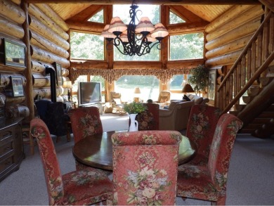 This stunning log home located on the 6th tee of Garland's on Garland Resort and Golf Club  in Michigan - for sale on GolfHomes.com, golf home, golf lot