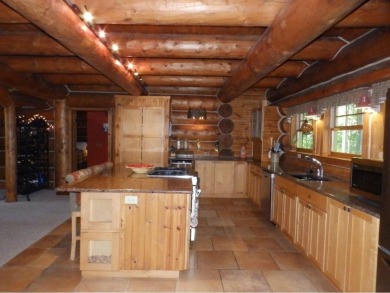 This stunning log home located on the 6th tee of Garland's on Garland Resort and Golf Club  in Michigan - for sale on GolfHomes.com, golf home, golf lot