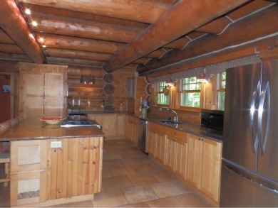 This stunning log home located on the 6th tee of Garland's on Garland Resort and Golf Club  in Michigan - for sale on GolfHomes.com, golf home, golf lot