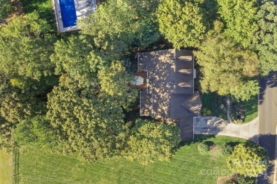 This stunning Muirfield home boasts mature trees and space for on Mooresville Golf Course in North Carolina - for sale on GolfHomes.com, golf home, golf lot