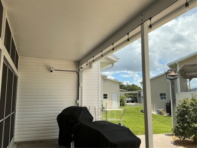 This home truly has it all! Attached RV port built to on Lily Lake Golf and RV Resort in Florida - for sale on GolfHomes.com, golf home, golf lot