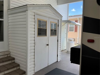This home truly has it all! Attached RV port built to on Lily Lake Golf and RV Resort in Florida - for sale on GolfHomes.com, golf home, golf lot