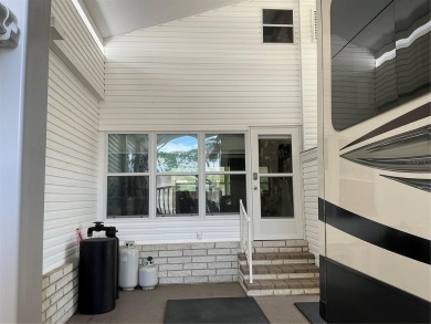 This home truly has it all! Attached RV port built to on Lily Lake Golf and RV Resort in Florida - for sale on GolfHomes.com, golf home, golf lot