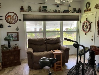 This home truly has it all! Attached RV port built to on Lily Lake Golf and RV Resort in Florida - for sale on GolfHomes.com, golf home, golf lot