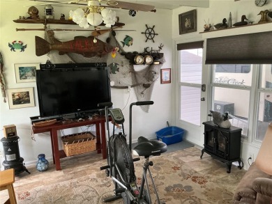 This home truly has it all! Attached RV port built to on Lily Lake Golf and RV Resort in Florida - for sale on GolfHomes.com, golf home, golf lot
