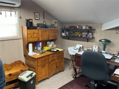 This home truly has it all! Attached RV port built to on Lily Lake Golf and RV Resort in Florida - for sale on GolfHomes.com, golf home, golf lot