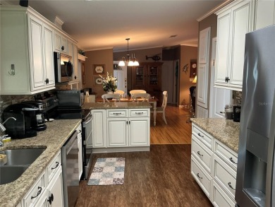 This home truly has it all! Attached RV port built to on Lily Lake Golf and RV Resort in Florida - for sale on GolfHomes.com, golf home, golf lot