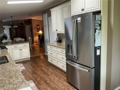 This home truly has it all! Attached RV port built to on Lily Lake Golf and RV Resort in Florida - for sale on GolfHomes.com, golf home, golf lot