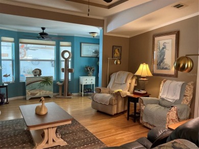 This home truly has it all! Attached RV port built to on Lily Lake Golf and RV Resort in Florida - for sale on GolfHomes.com, golf home, golf lot