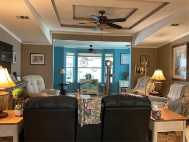 This home truly has it all! Attached RV port built to on Lily Lake Golf and RV Resort in Florida - for sale on GolfHomes.com, golf home, golf lot