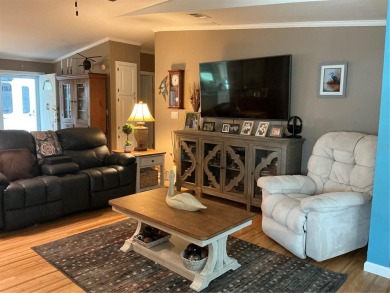 This home truly has it all! Attached RV port built to on Lily Lake Golf and RV Resort in Florida - for sale on GolfHomes.com, golf home, golf lot
