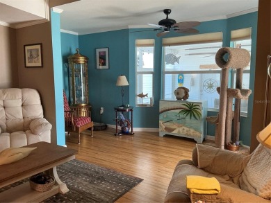 This home truly has it all! Attached RV port built to on Lily Lake Golf and RV Resort in Florida - for sale on GolfHomes.com, golf home, golf lot